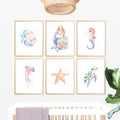 Mermaid Nursery Wall Art Prints Set of 6 featuring watercolor mermaid, tropical fish, seahorse, jellyfish, starfish, and sea turtle prints for a coastal baby girl room, under-the-sea ocean nursery decor for digital download, large printable wall art. 