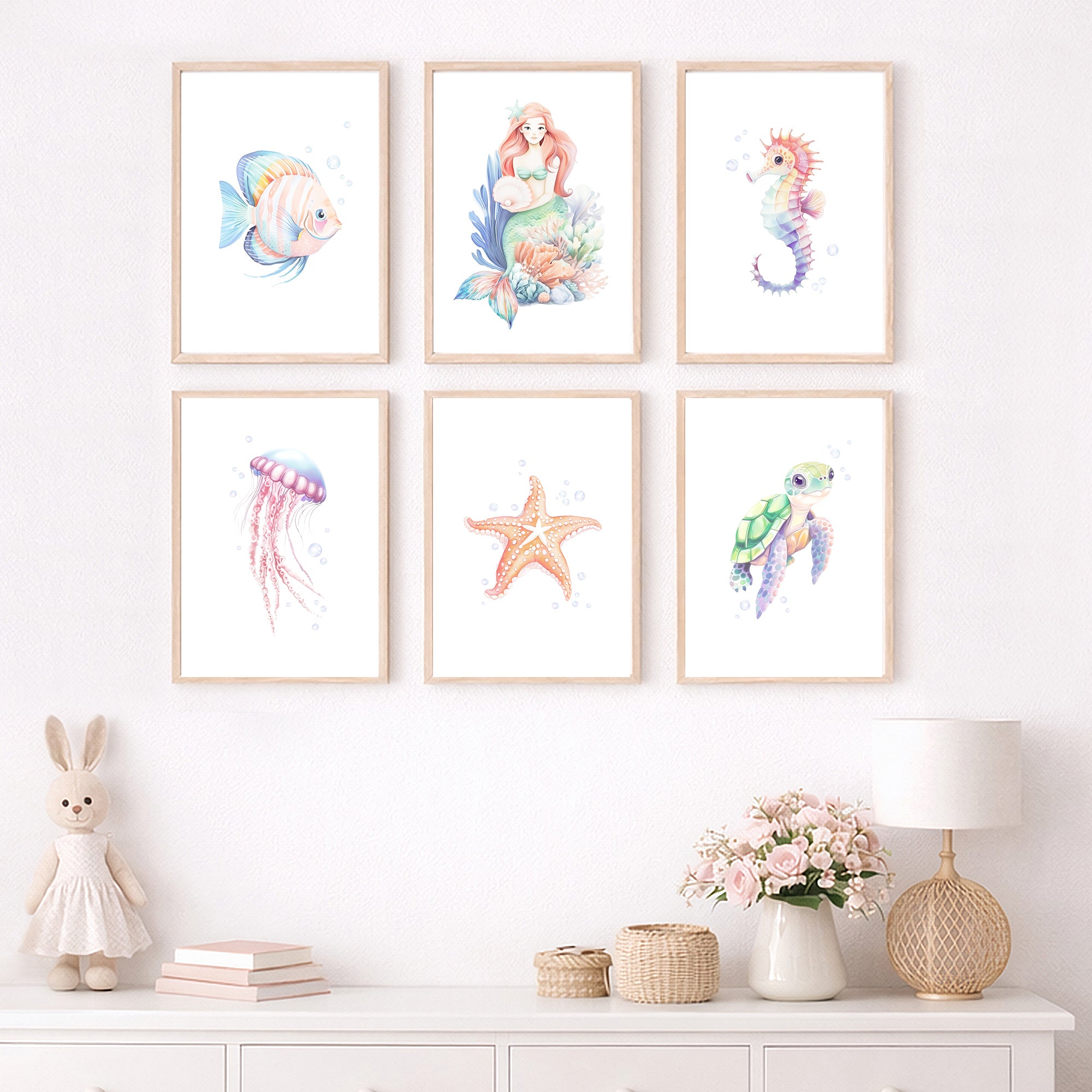 Mermaid wall art, Watercolor Ocean Nursery Wall Art Prints Set of 6, including mermaid, sea animals, tropical fish, seahorse, jellyfish, starfish, and sea turtle prints in a modern baby girl room. Under the sea wall art decor for digital download, large printable wall art